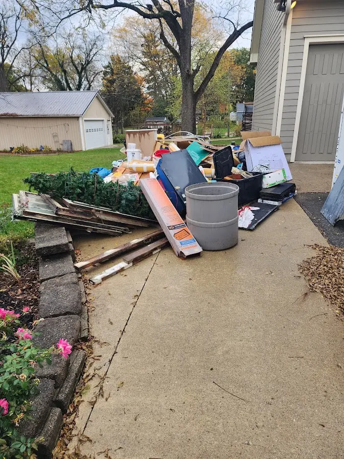 Dumpster being loaded with debris for Roofing Dumpster Rental in Wahoo